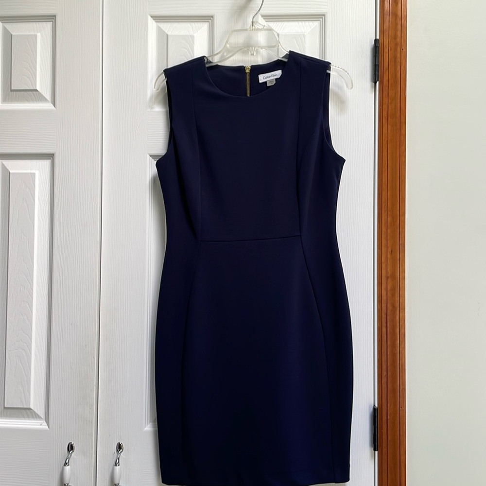 Classic navy dress, fitted style, size 10. Gold zipper on back.
